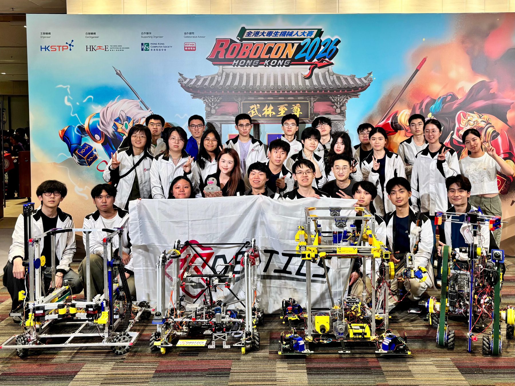 PolyU Robocon team posing with robots at the Robocon 2026 Hong Kong venue